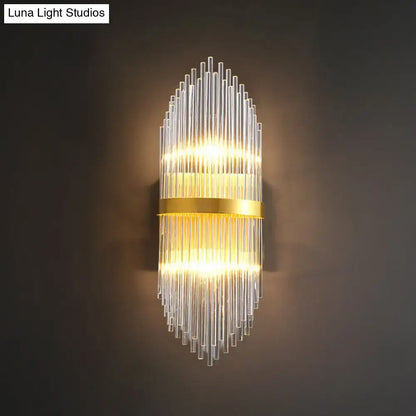 Modern gold flute shaped wall sconce with clear crystal rods and cascading glass design for elegant bedroom lighting