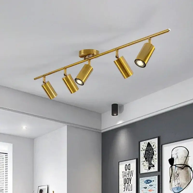 Gold-colored decorbites adjustable led ceiling spotlight with four adjustable spotlights on a modern bar fixture