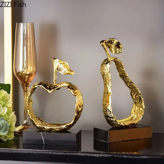 Modern gold fruit shaped metal crafts featuring textured apple and pear decorbites fruit shaped accents on marble bases
