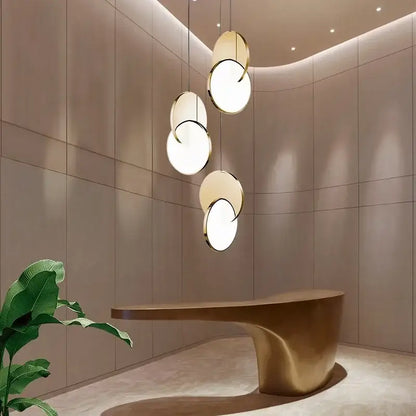 Modern gold geometric circle pendant light with overlapping discs features sleek minimalist design for dining room decorbites geometric circle