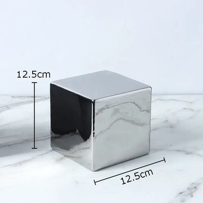 A sleek 12.5cm cube round statue planter in polished silver ceramic for modern living room decor