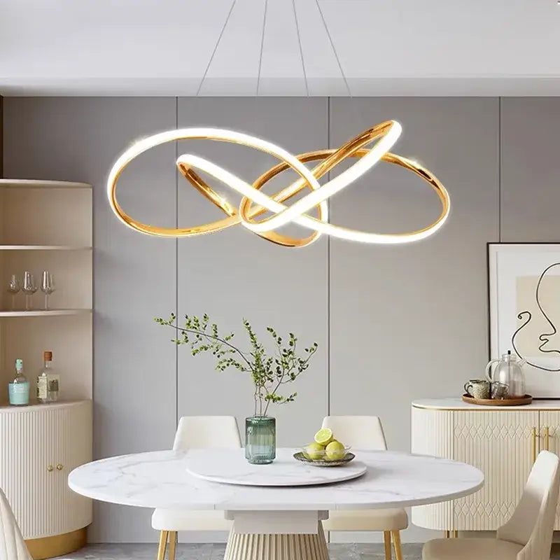 Modern gold geometric line led chandelier featuring a gold infinity-loop pendant light with illuminated led rings for dining decorbites geometric line