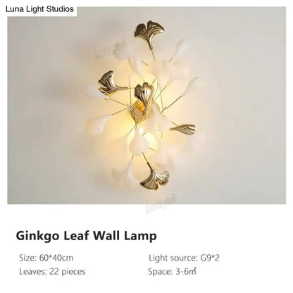Modern gold ginkgo leaf porcelain wall sconce with central brass fixture and 22 translucent white petals tipped in gold