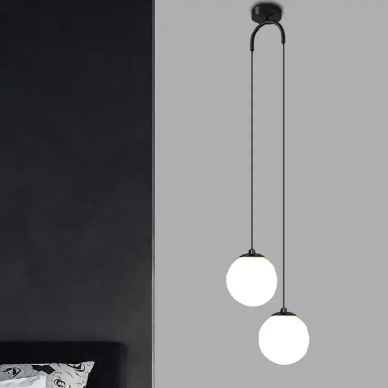 Black metal pendant light with two frosted glass ball dual globes on curved arm modern decorbites glass ball design