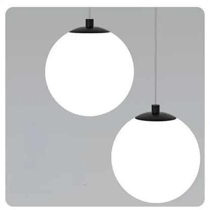Modern gold glass ball dual head pendant light featuring two matte black metal fixtures with frosted white glass globes