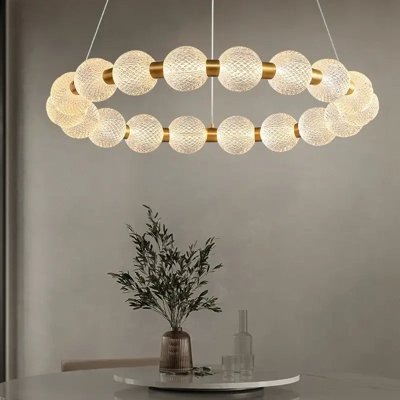 A modern gold glass ball led ceiling chandelier with frosted glass spheres and metal accents for living room decorbites