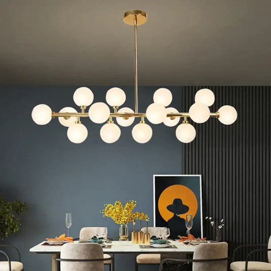 Modern gold glass ball led chandelier with frosted globes in linear branching design for kitchen and dining room decorbites