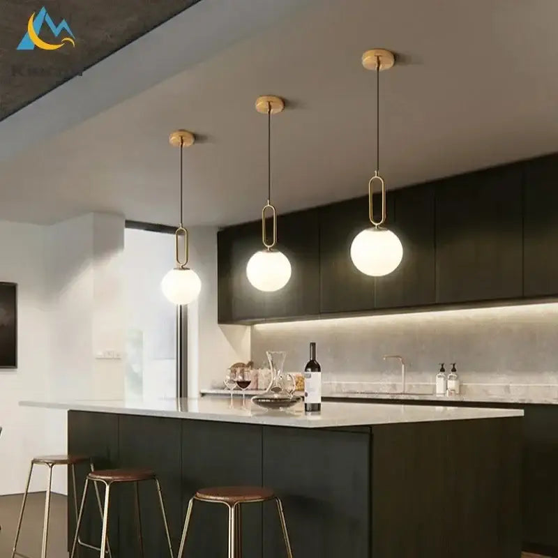 Three modern gold glass ball led pendant lights with frosted globes and brass frames for living room decorbites glass ball