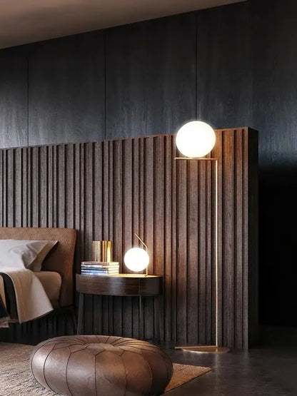 Modern gold floor lamp with a spherical white glass ball led shade and slender metal stand perfect for chandelier light decorbites