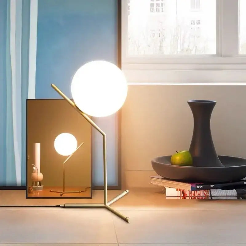 Modern gold brass-finished table lamp with spherical frosted glass globe featuring decorbites glass ball led design