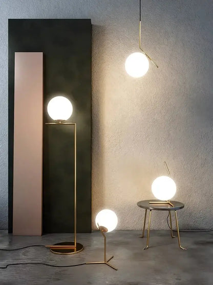 Modern gold glass ball led chandelier light with gold-toned minimalist table lamps and frosted spherical glass shades