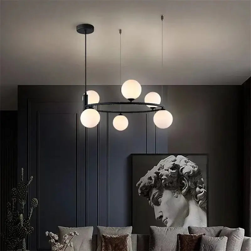 Modern black metal ball pendant chandelier with six frosted glass globe lights for dining room decorbites glass ball