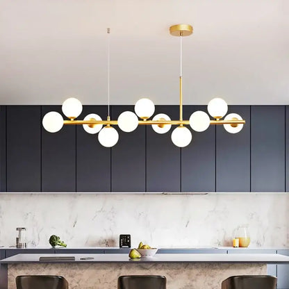 Modern gold glass ball pendant light with multiple white glass bulbs in a linear design for dining room decorbites chandelier