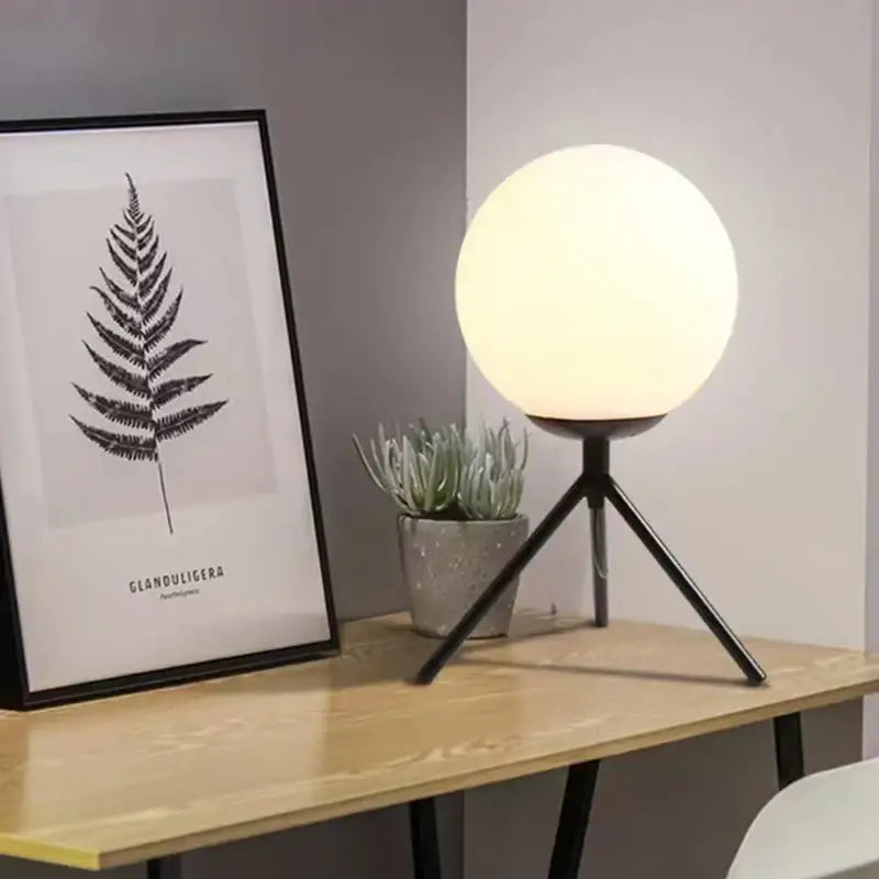 Modern glass ball table lamp with frosted white glass globe and black metal tripod base for bedroom decorbites decor