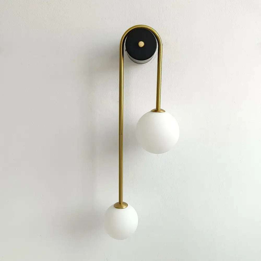 Modern gold glass ball wall lamp with dual frosted white glass shades and black circular mounting plate decorbites glass ball