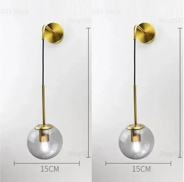 Modern gold glass ball wall lamp with clear glass globe and minimalist brass bracket perfect for bedroom decorbites glass ball
