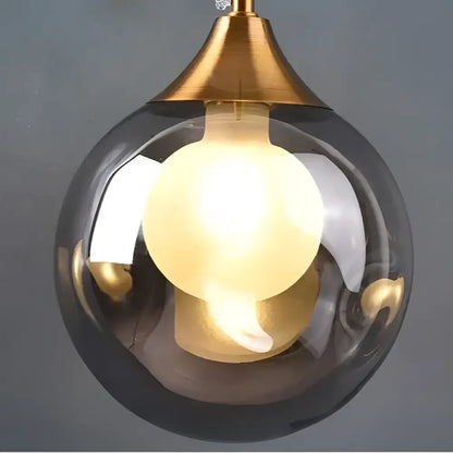 Modern gold glass ball wall sconce with smoked glass globe and brass-toned metal fixture for bedroom decorbites glass ball