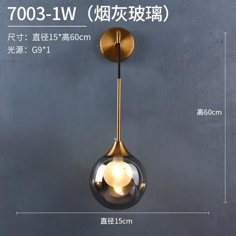 A modern gold wall sconce with a brass frame and smoked glass ball perfect for bedroom decorbites glass ball lighting
