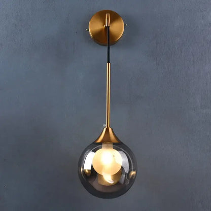 Modern gold wall sconce with a sleek glass ball shade and minimalist metal stem for bedroom decorbites glass ball lamp