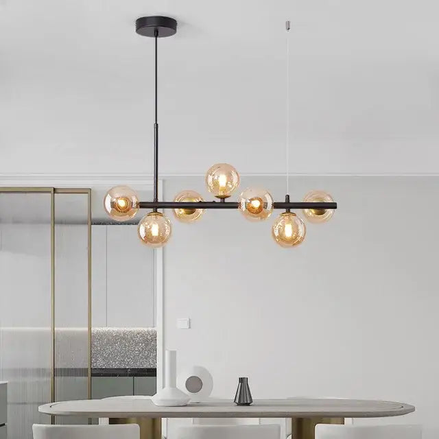 Modern black metal chandelier pendant light with warm amber glass globe bulbs and metal structure as focal point
