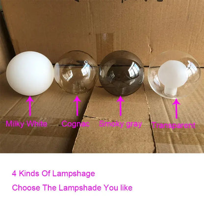 Modern gold glass globe pendant light with four spherical milky white cognac smoky gray and transparent lampshades metal structure