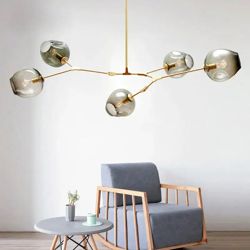 Modern brass pendant lights with five smoked glass globe shades ideal for dining room glass pendant lighting