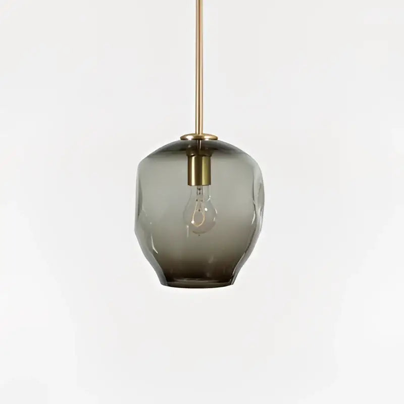 A sleek dark gray textured glass pendant light with brass fixture for modern gold glass pendant lights in dining room