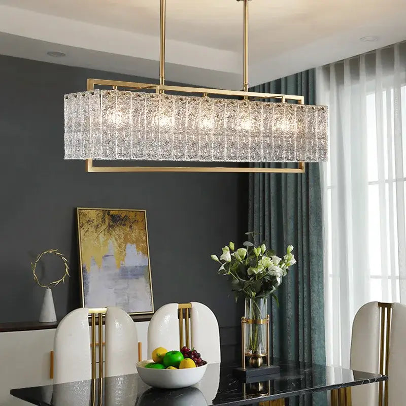 Modern gold glass restaurant chandelier with textured crystal body and sleek metal frame for luxury dining room lighting