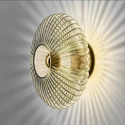 Modern gold glass ripple led wall lamps featuring a translucent ribbed glass sconce with a circular opening