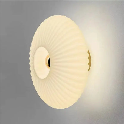Cream-colored ribbed glass ripple led wall lamp with gold-toned mounting bracket for modern bedroom decoration