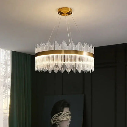 Modern gold pendant chandelier with glass rod led design and clear glass rods emitting warm light for dining room