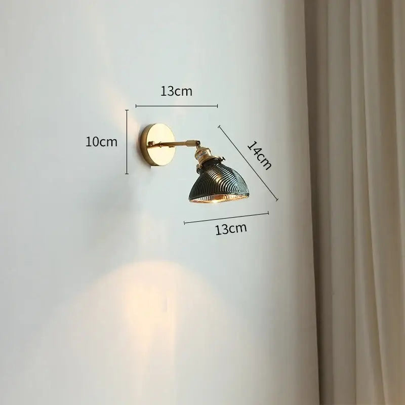 Vintage-style led wall light with brass mounting plate and dark green ridged glass shade for bedroom use