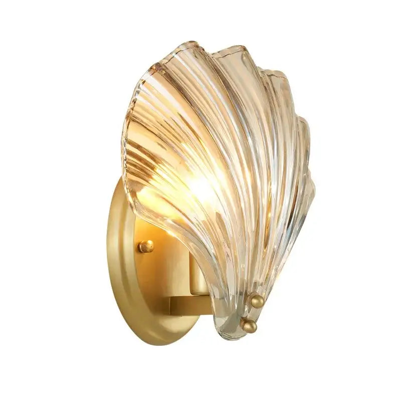 Modern gold glass shell led wall lamp with translucent ribbed glass and brass finish emitting a warm golden glow