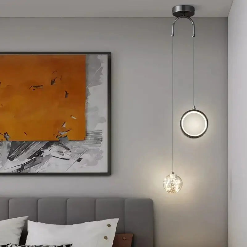 Modern gold glass starry led pendant lights featuring a sleek circular metallic fixture with two spherical glass shades