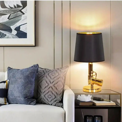 Modern gold gun floor lamp with black fabric shade by decorbites for stylish living room lighting and decorbites gun floor design