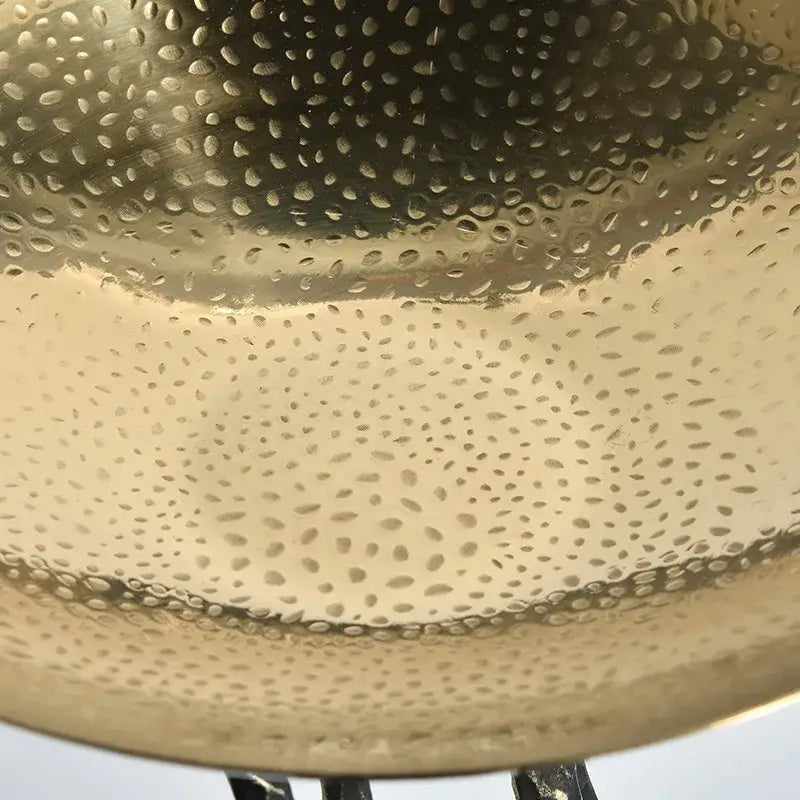 Modern gold hammered fruit bowl tray featuring a textured dimpled metal surface for elegant dining room decor