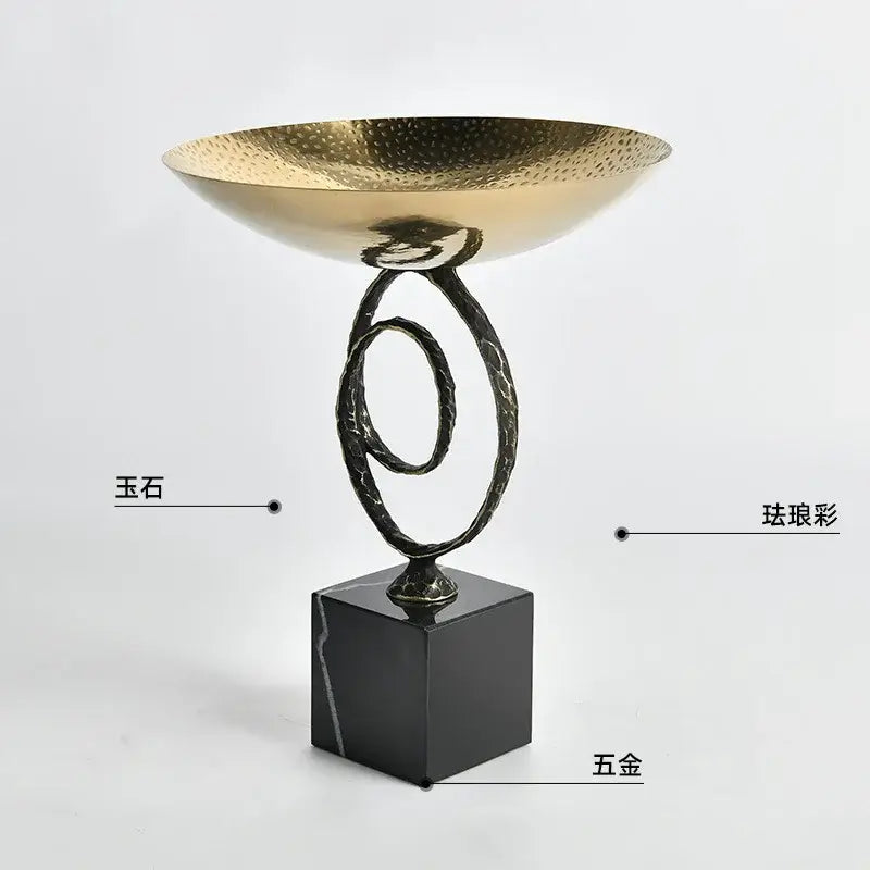 Modern gold hammered fruit bowl tray with twisted black metal stand and black marble base for dining room use