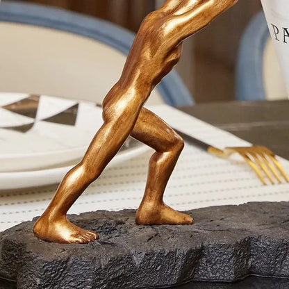 Modern gold hercules figurines wine rack featuring a golden bronze muscular male figure on black stone base decorbites hercules figurines