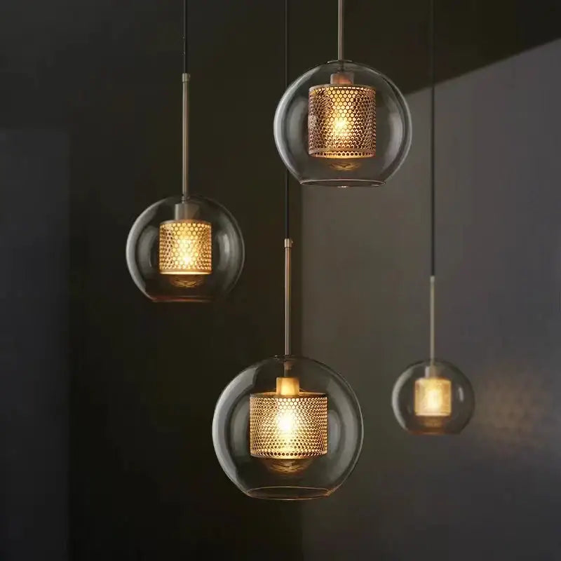 Modern gold honeycomb glass pendant lights with warm-toned textured brass mesh shades for dining room fixtures