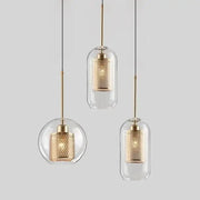 Modern gold honeycomb glass pendant lights feature clear glass pendant shades with gold-toned honeycomb interiors for dining rooms