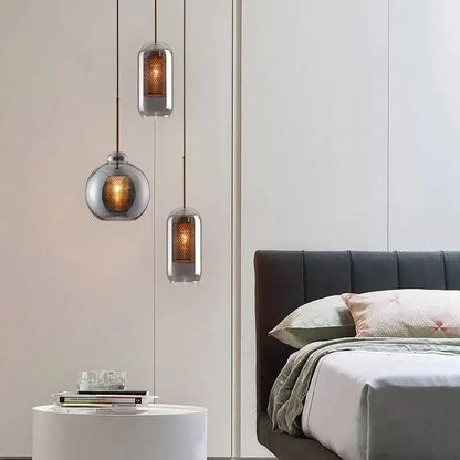 Three modern gold honeycomb glass pendant lights with frosted shades and warm lighting for dining room use