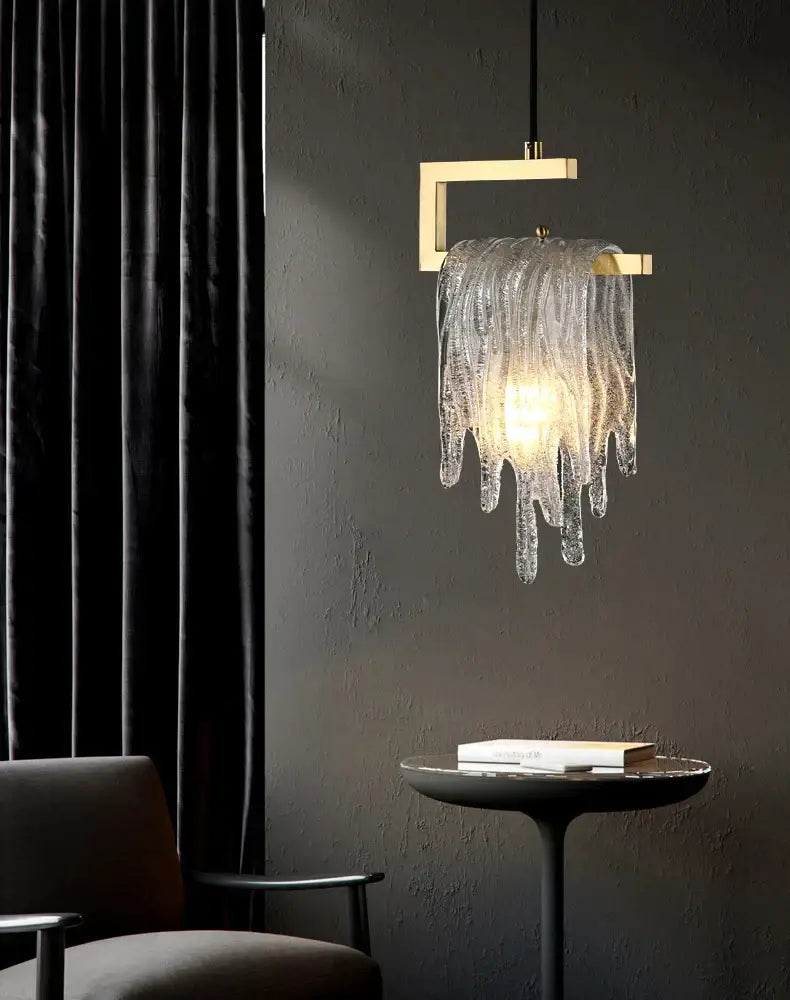 A modern gold icicle glass pendant light with a metal frame and cascading translucent shades for bedroom decorbites decor