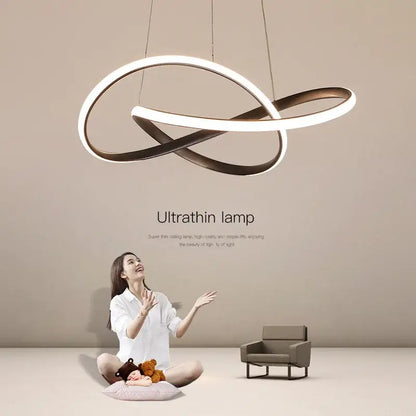 Modern gold infinity loop cord pendant light with sleek white and bronze metallic rings for dining room lighting
