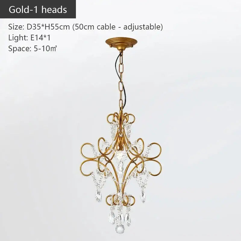Modern gold iron crystal chandelier with intricate scrollwork and dangling crystal droplets for luxury dining room decorbites iron crystal lighting
