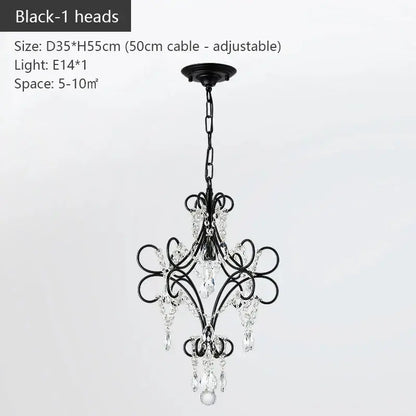 Modern gold iron crystal chandelier featuring black wrought iron scrollwork and crystal droplets for luxury dining decorbites iron crystal lighting
