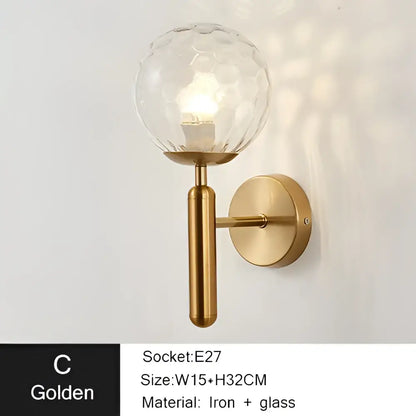 Modern gold iron led sconce lamp with textured spherical glass and brass-finished base for bedroom decorbites iron led