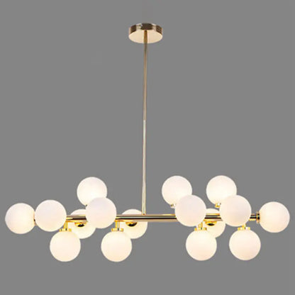 Modern gold island pendant light with frosted glass globe bulbs in a symmetrical branching design for living room