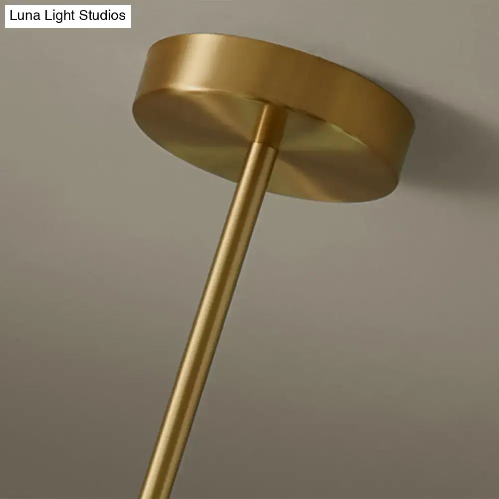 Modern gold island pendant lighting with brass finish cylindrical stem and circular mounting plate for dining room island pendant