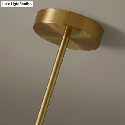 Modern gold island pendant lighting with brass finish cylindrical stem and circular mounting plate for dining room island pendant