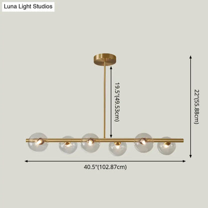 Modern gold island pendant lighting with five clear glass globe shades in brass for dining room pendant lighting